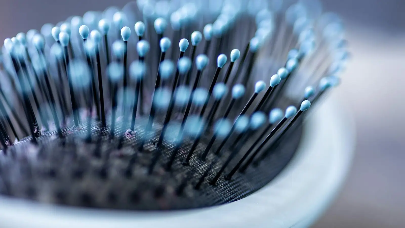 Close detail of an unbranded blue hairbrush