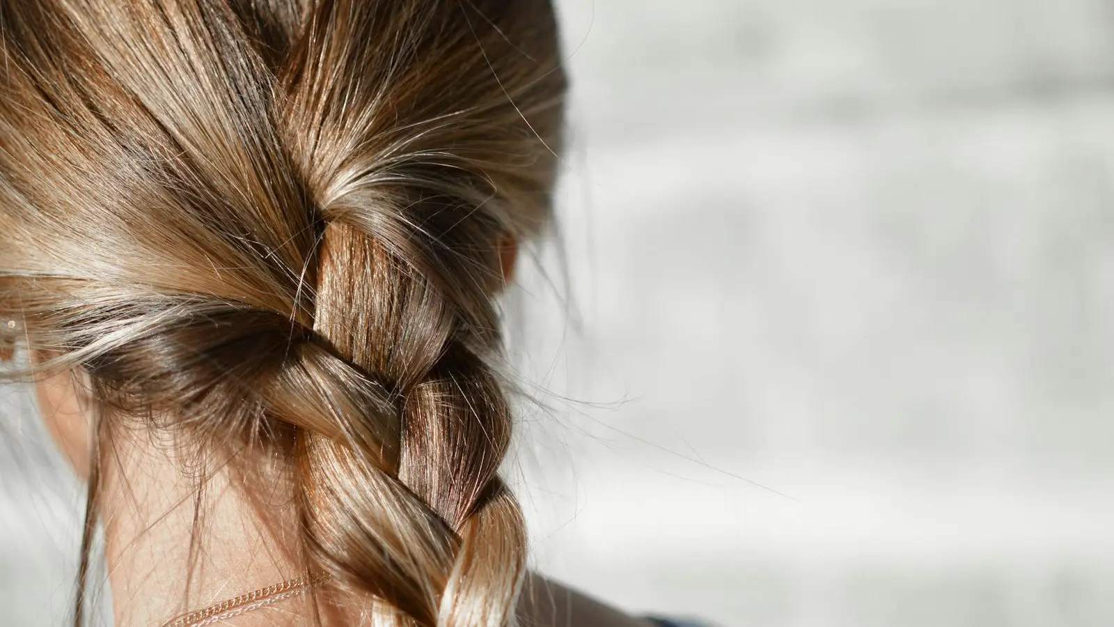 Close view of a braid in brown hair seen from behind
